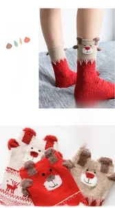 Detail showing plush Christmas socks with reindeer ears and festive snowflake patterns