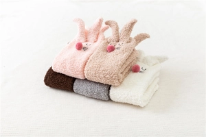 Detail of coral fleece rabbit socks in pink, khaki, white, brown and grey colors