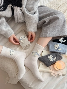 Détail de la maille de chaussettes en laine à motif chat montrant le tissu chaud et douillet