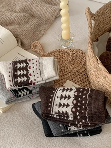 Close-up of thick wool socks with Nordic Fair Isle patterns in warm winter home setting
