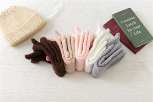 Flat lay of five pairs of soft coral fleece rabbit socks in assorted warm autumn colors