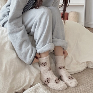 Warm coral fleece socks featuring cute bear patterns for cozy winter indoor lounging