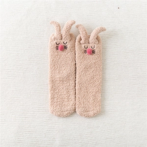 Detail of coral fleece rabbit socks with plush ears and embroidered cartoon face