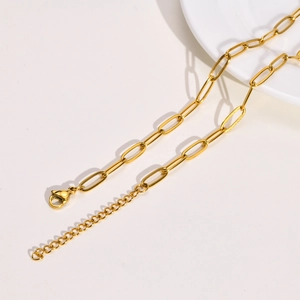 Detail view of golden stainless steel paperclip chain necklace with lobster clasp