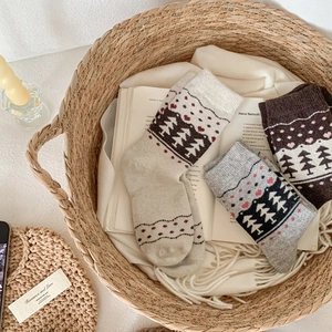 Detailed knit texture of Nordic wool socks with heart and tree jacquard patterns