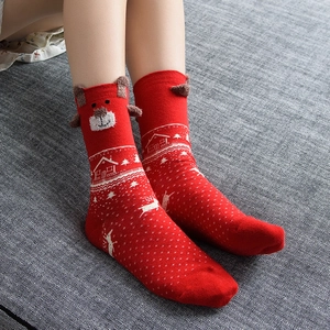 Red Christmas crew socks with white reindeer patterns and 3D plush bear ears detail