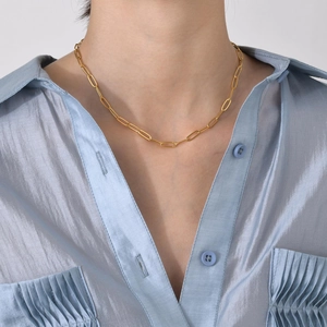 Elegant golden paperclip chain necklace for women shown on model with blue silk shirt