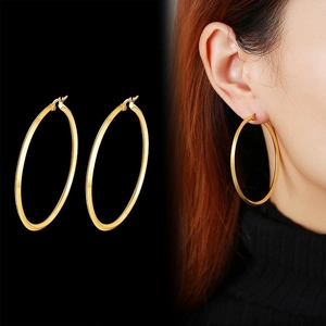 Polished gold wide flat hoop earrings for women, featuring a minimalist chunky metal design