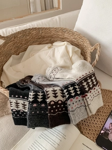 Detail of Fair Isle pattern knit wool socks neatly stacked in a cozy winter setting