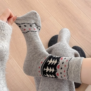 Winter wool socks with Fair Isle tree patterns, showcasing thick knit texture and elasticity