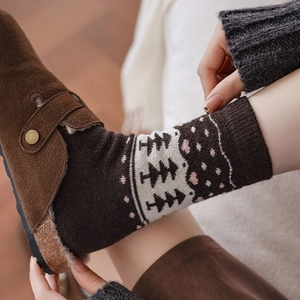 Winter wool socks with Fair Isle pattern worn with suede clogs in cozy home setting