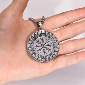 Gros plan du pendentif viking avec symbole Aegishjalmur et inscription Valhalla