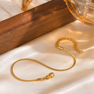 Elegant 18k gold plated stainless steel S-link chain bracelet on silky cream fabric
