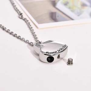 Macro view of heart cremation urn necklace with Forever In My Heart engraving and screw seal