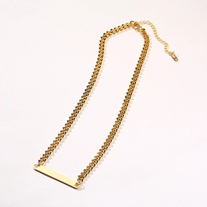 Detail of 18K gold-plated bar pendant on a chunky Cuban chain with lobster clasp