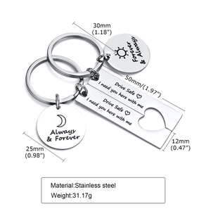 Detail of stainless steel couple keychain set with heart puzzle and sun moon charms