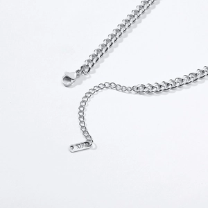 Macro view of polished stainless steel cuban chain with lobster clasp and K18 tag