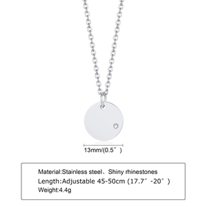 Detail view of 13mm gold stainless steel round pendant with a small zircon accent