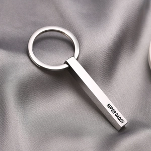 Macro shot of silver stainless steel rectangular keychain engraved with SUPER DADDY