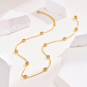 Gold titanium steel necklace with circular white zircons on minimalist cable chain