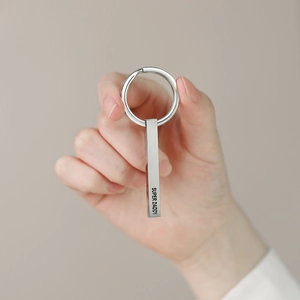 Close-up of polished stainless steel keychain featuring Super Daddy engraved pendant