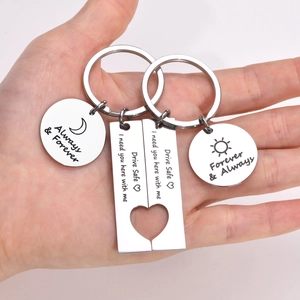 Detail of stainless steel keychains with sun moon patterns and drive safe engravings