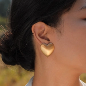 Minimalistische mattierte 18K vergoldete Herzohrringe an einem Model für elegantes Styling