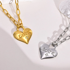 Gold and silver heart pendant necklace with LUCK engraving and paperclip chain