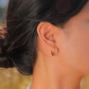Fashionable 18K gold-plated zircon hoop earrings for women shown on a model outdoors