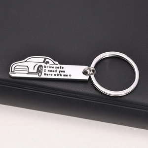 Close-up of car-shaped stainless steel keychain with Drive Safe sentimental engraving
