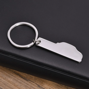 Polished stainless steel racing track outline keychain on black leather background