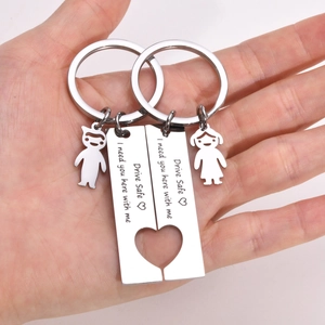 Detail of stainless steel puzzle keychain with heart cutout and Drive Safe engraving