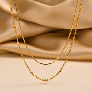Golden double-layer stainless steel necklace with sleek snake chain and beaded detail