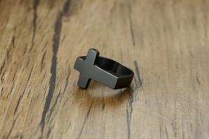Close-up of black titanium steel cross ring for men with minimalist gothic design features