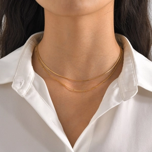 Double-layered gold stainless steel necklace with sleek snake chain and beaded detail for women