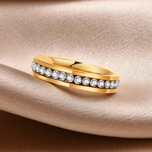 Close-up of a rose gold ring featuring channel-set clear cubic zirconia on silk fabric