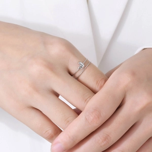 Close-up of double-layer stainless steel heart ring with micro-pave stones on model