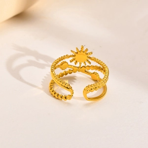 Detailed close-up of golden stainless steel sun ring featuring a layered open band design
