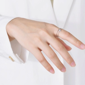 Detail of silver double-layered ring with sparkling butterfly on fingers