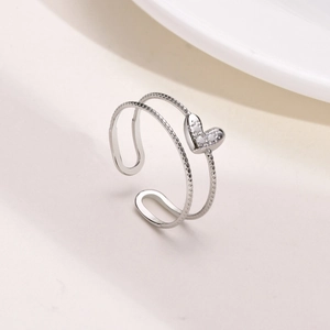 Detail of silver double-layered open ring with sparkling heart-shaped zircon inlay