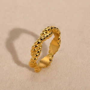 Polished golden stainless steel twisted rope ring with a smooth brushed inner finish