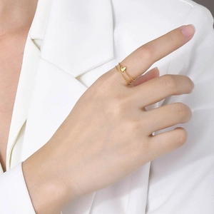 Polished golden heart double-layer open ring for women on finger with white blazer