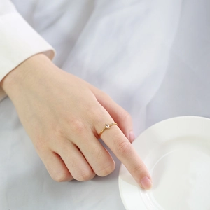 Minimalist gold stainless steel ring with marquise zircon on model finger