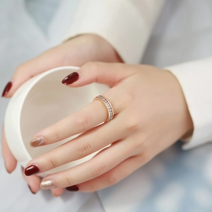 Elegant rose gold plated stainless steel ring with micro-pave crystals on female hand