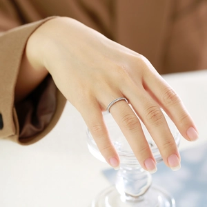 Close-up of minimalist silver eternity ring with zircon stones on a female hand
