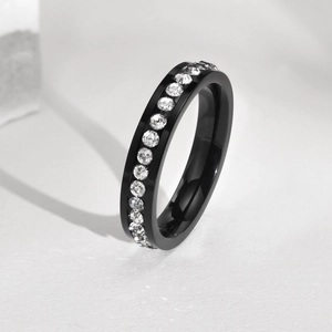 Macro shot of black titanium steel band featuring channel-set white cubic zirconia stones