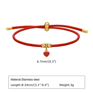 Detail of adjustable red cord bracelet with stainless steel beads and heart pendant