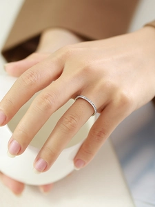 Close-up of minimalist silver stainless steel ring with micro-paved cubic zirconia