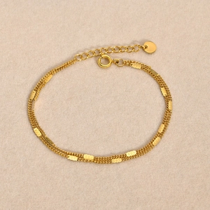 Detail of gold double-layer chain bracelet with spring clasp and adjustable extender chain