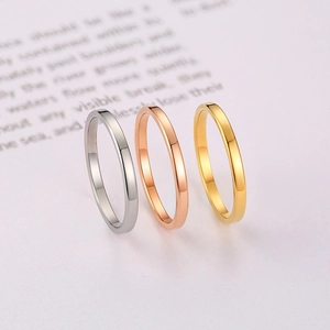Three-piece set of thin polished minimalist rings in silver, gold, and rose gold finishes